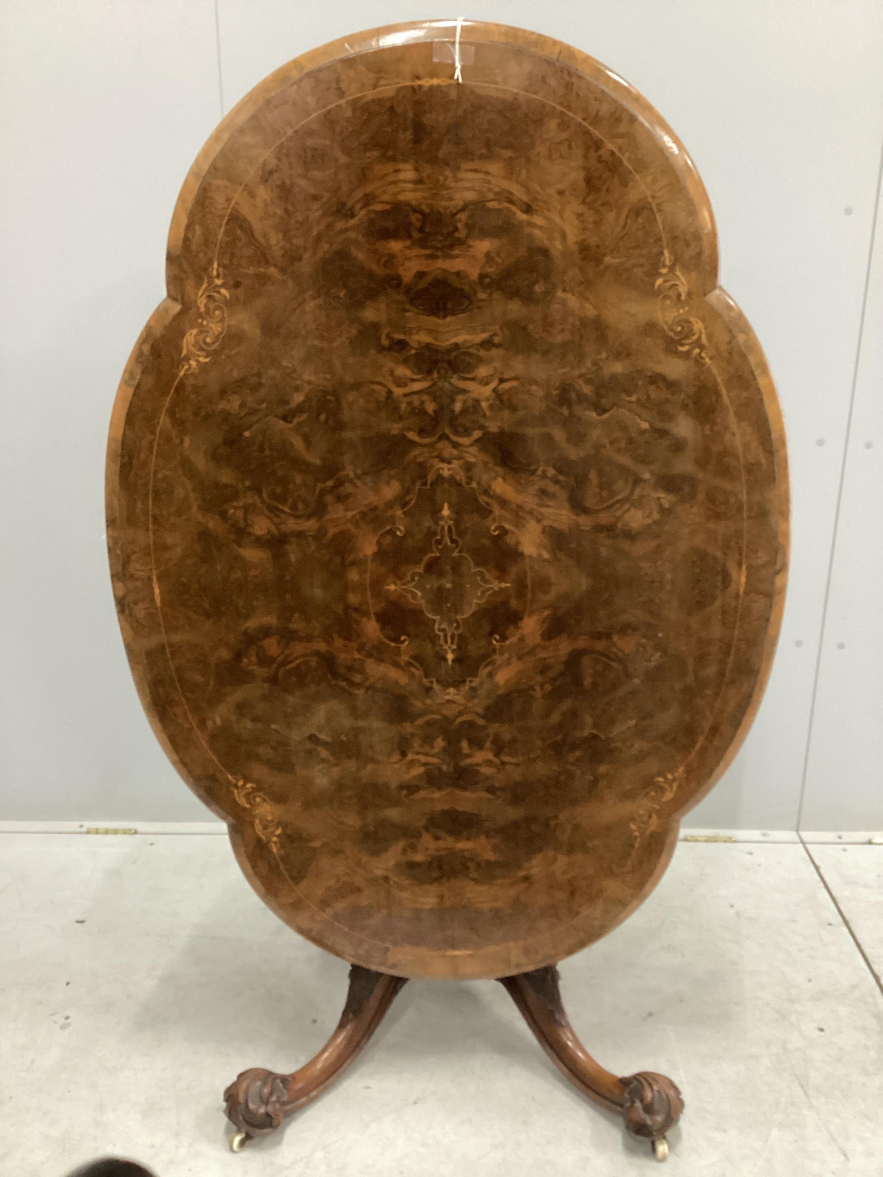 A set of four Victorian carved walnut dining chairs, bearing label - ‘’Taylor & Sons, Furniture Manufacturer, Dover Street, London’’, together with a mid Victorian inlaid walnut oval topped dining table, table width 130c